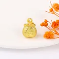 Macro shot of a golden lucky bag pendant featuring embossed Fu character and sand gold texture - 15# Sand Gold Lucky Pouch