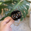 Close-up of a glossy black acetate cartoon puppy hair claw clip with glasses detail - Eyeglasses Black Puppy