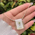 Detail of 18K gold-plated necklace featuring a cartoon Virgin Mary fabric pendant with beads - Cartoon Virgin Mary
