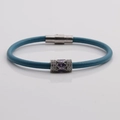 Detail of blue leather bracelet featuring a purple zircon bead and silver magnetic clasp - Blue Leather + Purple Stone