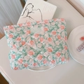 Detail of floral quilted cotton makeup bag with 'simple wish' label in aesthetic setting - Green Leaf Red Rose