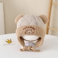 Detail of embroidered bear character and quilted texture on a warm winter earflap hat - 2-5 Years Old / Khaki
