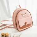 Pink and brown mini leather backpack with gold bow and textured litchi finish - Pink