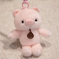 Plush pink pig keychain with fluffy fur, a brown fashion tag and a matching plastic hook - Pink Pig