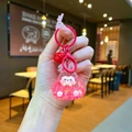 Detail view of a pink resin hamster keychain with red bell and glitter liquid filling - Colorful Hardware Keychain Style / Luminous Bubble Beads Tata (Red)