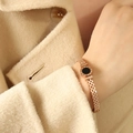Rose gold Roman shell bracelet with black center disk on a woven mesh metal band - Rose Gold