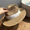 Handmade straw sun hat with wide white ribbon and hollow weave on a rustic wooden desk - Hollow Khaki Panama Hat - Beige Ribbon