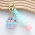 Porte-clés patte de chat dégradé rose et bleu avec paillettes sur plateau en bois - Bleu