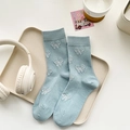 Light blue mid-calf socks featuring white bow jacquard patterns and ribbed texture - Bow / Blue
