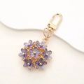 Detail view of a purple floral keychain charm with a gold-tone metallic lobster clasp - Charm / K403 Purple Flower