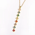 Detailed view of long gold chain necklace featuring eight multi-colored clover pendants - Gold