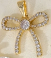 Golden bow pendant with pavé cubic zirconia inlay on textured beige background - Full Zircon Bowknot-ZTP0066