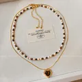 Detail of beaded necklace and gold heart pendant with tiger eye stone inlay - Double Layer Heart Tiger Eye (15#)