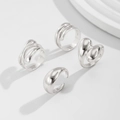 Macro view of fluid irregular silver rings set with glossy polished metallic finish - Minimalist Fluid Ring Set (04 White K 5680)