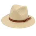 Detail of straw Panama hat featuring a brown leather band with decorative tassels and buckle - Beige