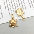 Detailed view of two golden sea turtle alloy pendants for DIY jewelry on vintage paper - 1Pc KC Gold Sea Turtle 18*11mm