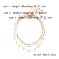 Detailed view of layered necklace set featuring sea shell beads and golden disc pendants - Gold Disc Rice Bead 3-Piece Set