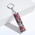 Detailed view of lipstick-shaped keychain with red and purple rhinestones - C9-Mixed Camo