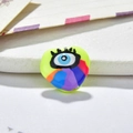 Macro detail of heart-shaped evil eye resin charm for DIY jewelry with vibrant neon finish - Fluorescent Yellow Rainbow