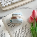 Light blue quilted headphone case with pearl charm and zipper for AirPods storage - Light Blue