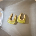 Macro detail of U-shaped lime green resin earrings with elegant golden metal hardware - Green