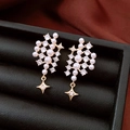 Close-up of pearl stud earrings with zircon star pendants on black leather jewelry box - Gold / Gold