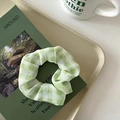Chic green and white plaid organza scrunchie displayed on a minimalist magazine tray - Green Checkered