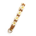 Handmade woven daisy keychain with white petals and yellow centers on caramel brown cord - Beige Coffee