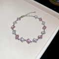 Detail view of silver bracelet with alternating pink and clear baguette-cut zircon stones - Bracelet - Silver - Pink - White