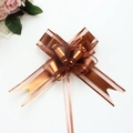 Close-up of matte dark brown organza pull bow for Christmas gift wrapping and decor - Coffee
