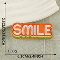 Self-adhesive orange embroidered patch with white SMILE text and green stripes - SMILE Orange