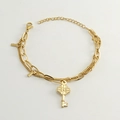 Detail of gold double-layer chain bracelet featuring floral key pendants and lobster clasp - Gold-Key