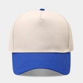 Close-up of a two-tone five-panel baseball cap with blue brim and reinforced stitching - Beige/Royal Blue