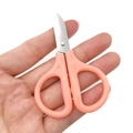 Portable mini pink scissors for DIY jewelry making and thread cutting held in palm - Pink Mini Scissors