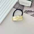 Elastic hair tie featuring a gold irregular textured metal ornament in a minimalist setting - Style N Light Gold