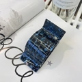 Detail of dark blue and black marble pattern acetate hair claw clip on magazine - Black Blue Spark