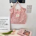 Detail of pink leopard heart canvas tote with buckle closure and brand label - Corduroy Leopard Heart Pink