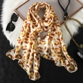 Long leopard print chiffon scarf in brown tones elegantly draped over fur with sunglasses - Abstract Leopard