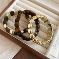 Detail view of amber resin and gold metallic square bead elastic bracelets on jewelry tray - 18# Amber Bracelet (HB4558)