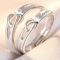 Macro shot of silver couple rings with Love engraving and heart infinity symbol - Eternal Union