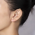 Gold lightning bolt ear cuff with small inlaid diamonds worn by a model on left ear - Gold Rhinestone Inlaid Lightning Bolt Ear Cuff (E361-GO)