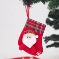 Red felt Christmas stocking with Santa Claus motif and plaid cuff hanging on a tree - Small Plaid Santa Stocking