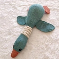 Durable blue plush wild goose dog toy with rope texture and orange feet on white rug - Green