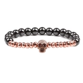 Natural stone beaded bracelet featuring hematite and rose gold beads with a skull charm - Rose Gold Skeleton