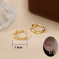 Detailed view of 1.4cm twisted gold Mobius hoop earrings with modern metallic finish - Irregular Wave Design / Gold