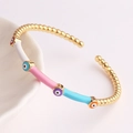 Close-up of golden Evil Eye open bangle with colorful enamel sections and bamboo pattern - Colorful