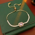 Detail view of the adjustable slider closure on gold bracelet with pink gemstone - Rectangular Pink Stone Pull Style / Gold-Pink