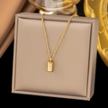 Elegant gold brick pendant necklace displayed on a brown leather jewelry box - AH154 Polished Gold Bar Gold