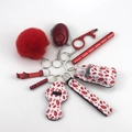 Detailed set of red survival keychain accessories including alarm and pompom on white - 10-Red Lips