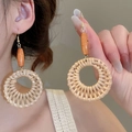 Detail of bohemian handmade rattan hoop earrings with natural wooden beads and gold hooks - Coffee Rattan Woven Round (16# Ear Hook)